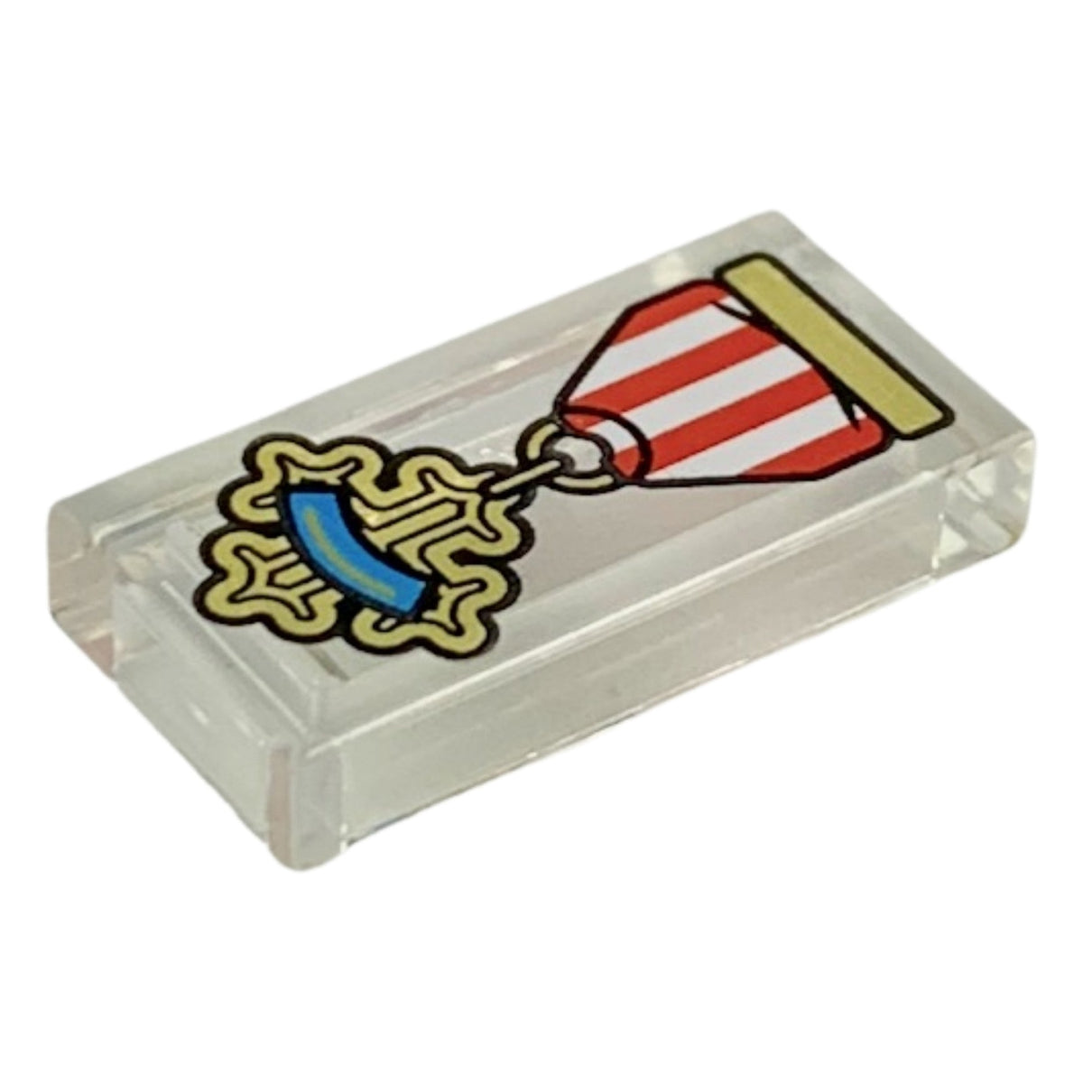 LEGO® Tile 1 x 2 with Red and White Ribbon, Gold Cross Medal with Dark Azure Stripe Pattern (transparent) 3069pb0697