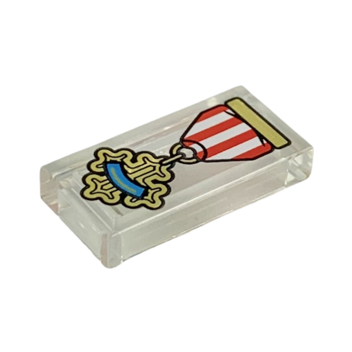 LEGO® Tile 1 x 2 with Red and White Ribbon, Gold Cross Medal with Dark Azure Stripe Pattern (transparent) 3069pb0697