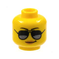 LEGO® Minifigure, Head Female Black Eyebrows, Sunglasses with Dark Silver Reflections, Medium Nougat Lips, Smirk Pattern 3626pb1778 gelb