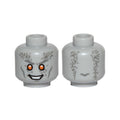 LEGO® Minifigure, Head Alien with White Teeth, Dark Bluish Gray Cheek Lines, Eyebrows and Wrinkles, Orange Eyes, Smile Pattern 3626pb3018 hellgrau